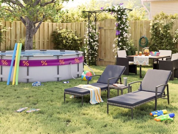 Aurinkoinen takapiha, jossa on maanp&auml;&auml;llinen uima-allas, allasnuudeleita, uimalasit, rantapallo ja varvastossut nurmikolla. Kaksi mustaa metallista aurinkotuolia harmailla pehmusteilla on pienen sivup&ouml;yd&auml;n vieress&auml;, ja ulkoruokailuryhm&auml; tummine punottuine tuoleineen on sijoitettu kukkivan pergolan, puuaidan ja vehreiden puutarhakasvien l&auml;helle.